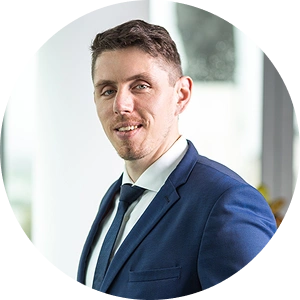 Core team member Michal Orviský smiling in a professional setting with a neutral background