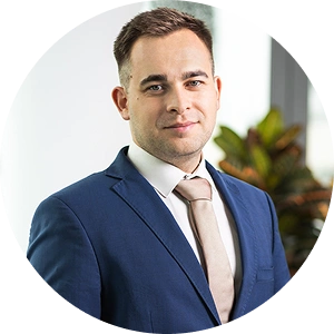 Core team member Vladimír Sedliak smiling in a professional setting with a neutral background