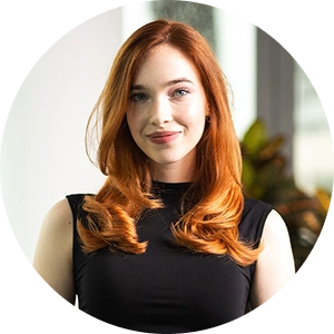 Core team member Ema Vrbovski smiling in a professional setting with a neutral background